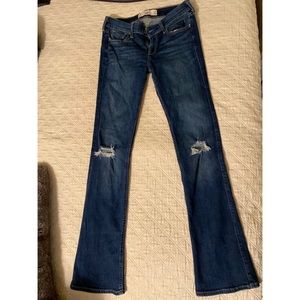 Dark wash boot cut distressed knee jeans